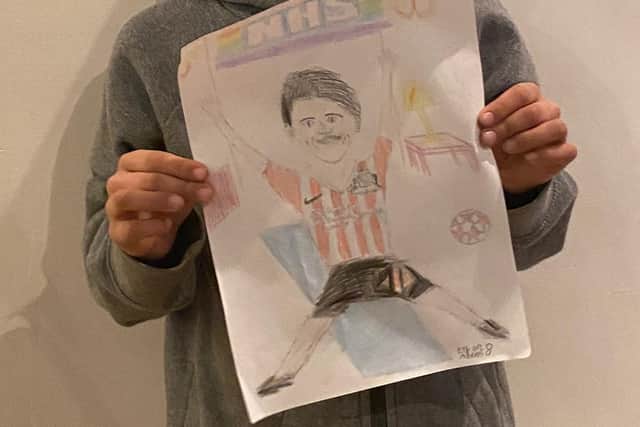 Ethan Adams with his drawing.