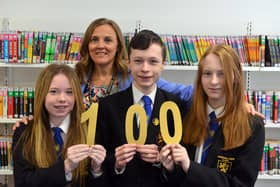 Sandhill View Academy triplet students Imogen, Michael and Milly Laing, 16, alongside headteacher Jill Dodd, celebrating their 100 per cent attendance throughout primary and secondary school.