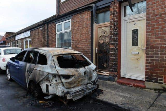 The flames melted front doors near the car which was destroyed in the arson attack