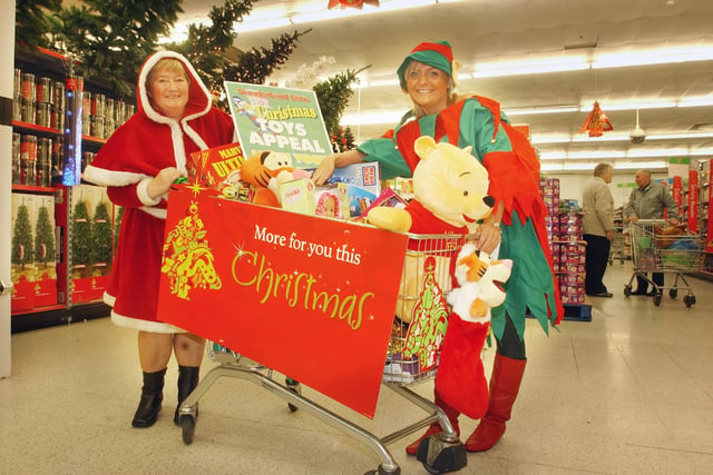 Santa got lots of help from an elf at Washington's Asda store as Christmas approached in  2006.