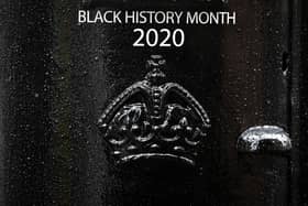 Detail on the front of a black postbox featuring an image of Second Lieutenant Walter Tull, on Byres Road, Glasgow, one of four special edition postboxes unveiled by Royal Mail to mark Black History Month.