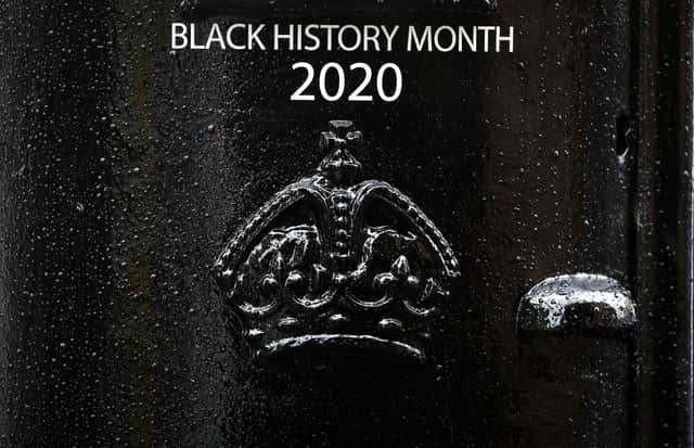 Detail on the front of a black postbox featuring an image of Second Lieutenant Walter Tull, on Byres Road, Glasgow, one of four special edition postboxes unveiled by Royal Mail to mark Black History Month.