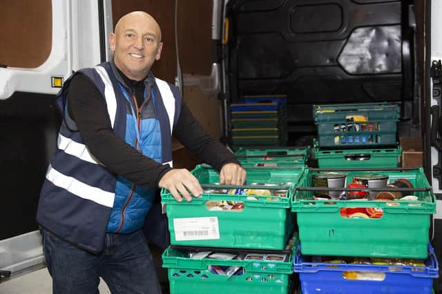 Phil Wright helps to load the food from the van.