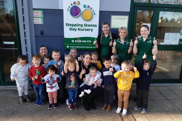 Nursery manager Terri Fos (centre) joins staff and children at Stepping Stones Day Nursery in giving a thumbs up to their good Ofsted report.