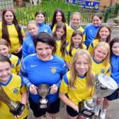 St Benet's all-conquering girls, with Georgie Rodda front right holding a trophy, are delighted to see England in the World Cup final. Sunderland Echo picture.