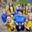 St Benet's all-conquering girls, with Georgie Rodda front right holding a trophy, are delighted to see England in the World Cup final. Sunderland Echo picture.