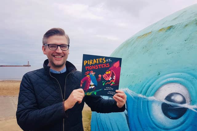 Sunderland author David Crosby with a copy of his new Pirates vs. Monsters picture book.