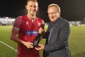 Former Scarborough FC boss Neil Warnock, right, presents the Betton Wines Man of the Match award to Athletic's Ash Jackson after the 2-2 draw with Bradford PA
