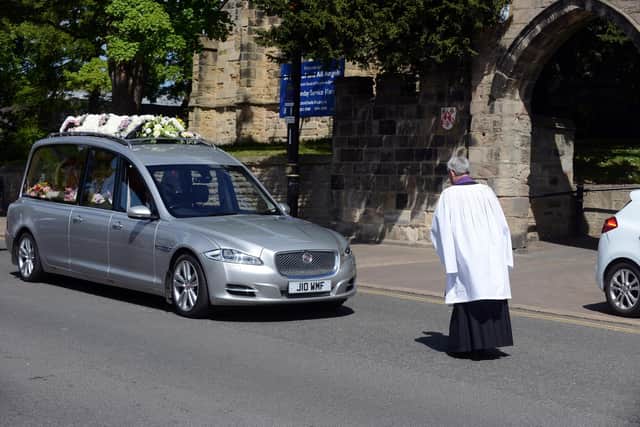 The funeral procession of Sheila Quigley at The Broadway outside St Michael's and All Angels.