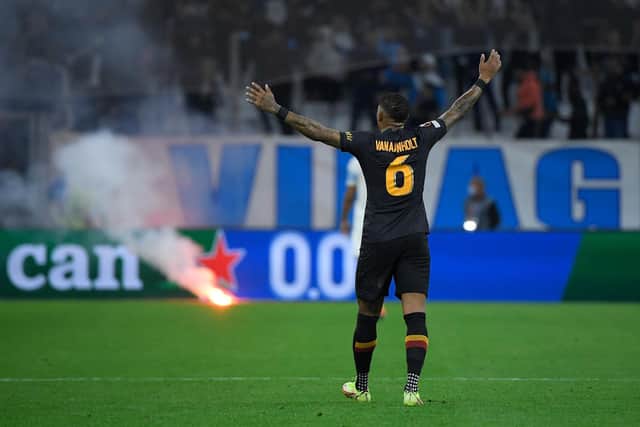 Galatasaray's Dutch defender Patrick van Aanholt reacts after a flare reached the pitch during the UEFA Europa League group E football match between Olympique de Marseille and Galatasaray AS at the Velodrome Stadium in Marseille, southern France on September 30, 2021. (Photo by NICOLAS TUCAT / AFP) (Photo by NICOLAS TUCAT/AFP via Getty Images)