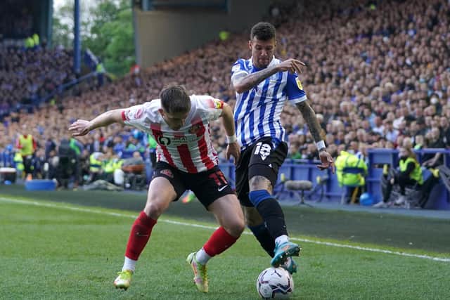 Sunderland's Lynden Gooch (left) and Sheffield Wednesday's Marvin Johnson battle for the ball during the Sky Bet League One play-off semi-final, second leg match at Hillsborough, Sheffield. Picture date: Monday May 9, 2022.