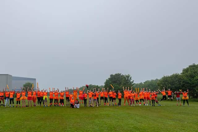 Runners turned the town orange while collectively running 2,000 miles in a week.