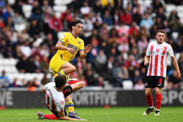 Sunderland defender Tom Flanagan goes in for a tackle against AFC Wimbledon.
