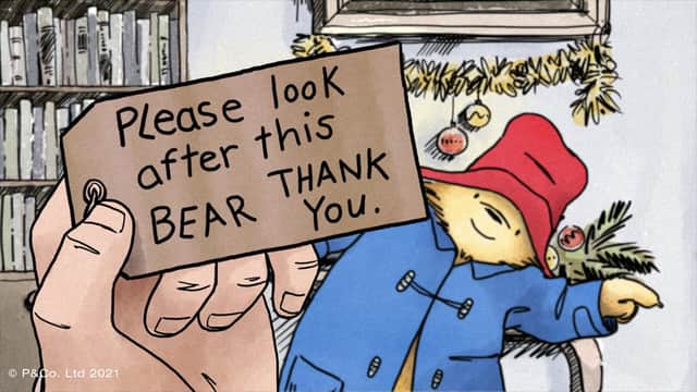 Mr Brown looks at the label that Paddington Bear was wearing when they first met.