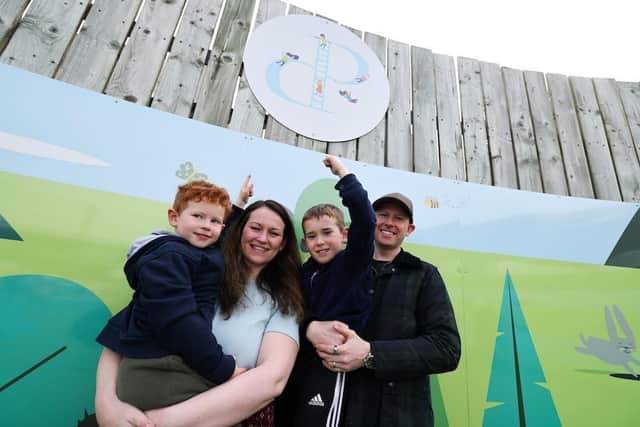Rhys Savin pictured (middle) with his mum Donna Savin, dad Scott Savin and brother Theo Savin (left)