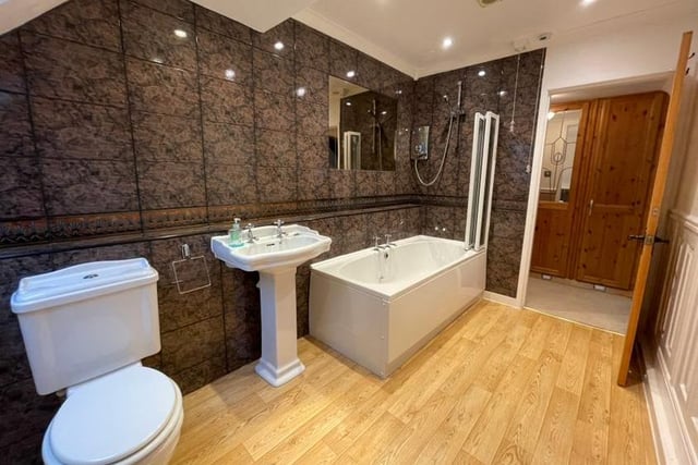 The master bedroom boasts this en suite. Beautifully appointed, it features a panelled bath with shower over, pedestal wash hand basin, lo-flush WC and a separate bidet. Not to mention tiling to full height and inset spotlights to the ceiling.