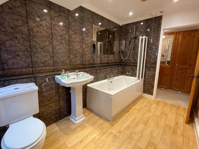 The master bedroom boasts this en suite. Beautifully appointed, it features a panelled bath with shower over, pedestal wash hand basin, lo-flush WC and a separate bidet. Not to mention tiling to full height and inset spotlights to the ceiling.