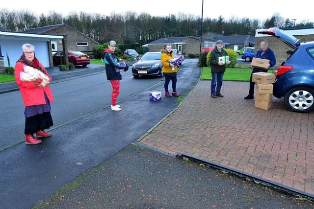 Cllr Bernie Scaplethorn (right) loads his car with donated hampers, with help from (left to right) Maureen Wilson, Kyle Barker, Samantha Scaplehorn and Brian Wilson from Feeding Families charity. Picture by Frank Reid.