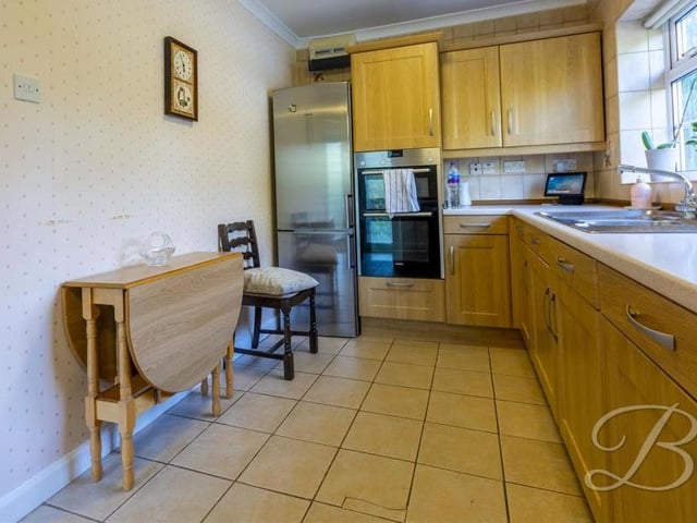 The kitchen has room for a breakfast table, and also space and plumbing for a dishwasher. A window looks into the conservatory.