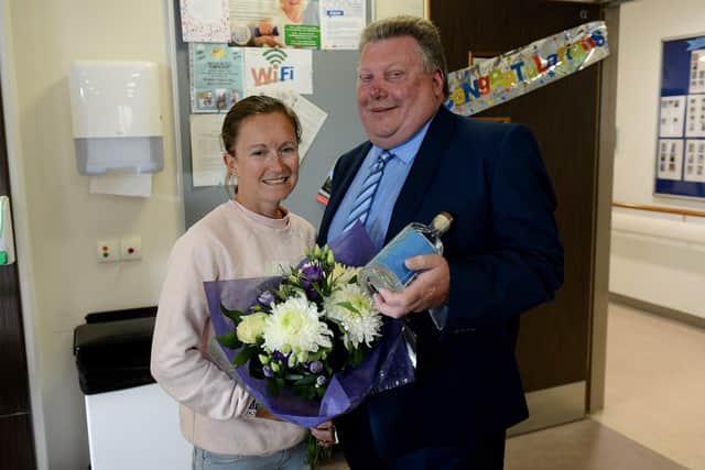 Great North Run runner Aly Dixon, a regular fundraiser for the hospice,  is presented with gifts by Derek Moss, chairman of the board of trustees at St. Benedict's Hospice before lockdown