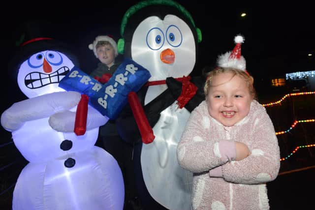Alfie Solomon, 11 and Gabriella Solomon, six, with the shivering snowman and penguin inflatables.