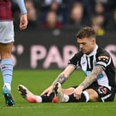 Newcastle full back Kieran Trippier sits down on the turf before leaving the field. (Photo by Stu Forster/Getty Images)