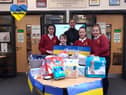 Pupils Sebastian Davey, 10, Izabella Wiseman, 11,  Amelia Rogerson, 11, and Eden Bleek, 11, with headteacher Ashleigh Sheridan and some of the donated items.