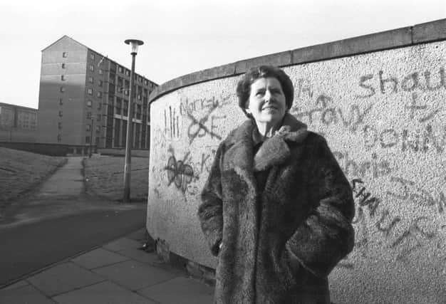 Dr Alice Coleman, author of 'Utopia on Trial' visiting Wester Hailes high-rise flats in Edinburgh, standing in front of a graffiti-covered wall in November 1986.