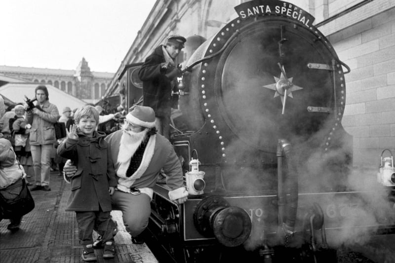 Michael Fielden (4) and father Christmas beside the Scottish Railway Preservation Society's steam locomotive Maude at Waverley station, running the Santa Special in December 1986.