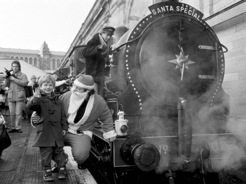 Michael Fielden (4) and father Christmas beside the Scottish Railway Preservation Society's steam locomotive Maude at Waverley station, running the Santa Special in December 1986.
