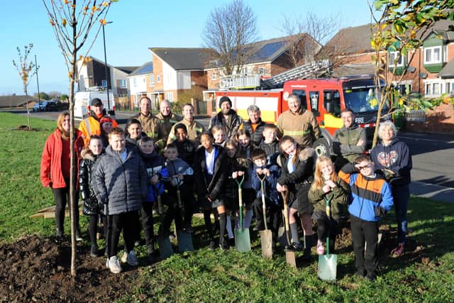 Pupils from Southwick Primary School and firefighters from Marley Park Community Fire Station help to replant the SARA community orchard at Cato Street, Southwick, Sunderland.