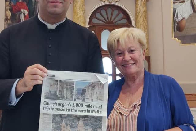 The priest in charge, Father Marc Andre Camilleri, pictured with Kath O’Leary who brought a copy of the Echo's article in May to the Basilica in Malta.