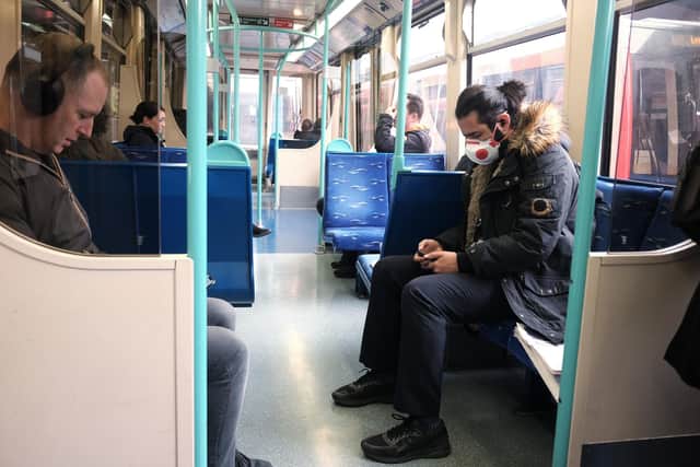 A passenger wearing a mask in London the day after Prime Minister Boris Johnson called on people to stay away from pubs, clubs and theatres, work from home if possible and avoid all non-essential contacts and travel in order to reduce the impact of the coronavirus pandemic. Picture: PA.