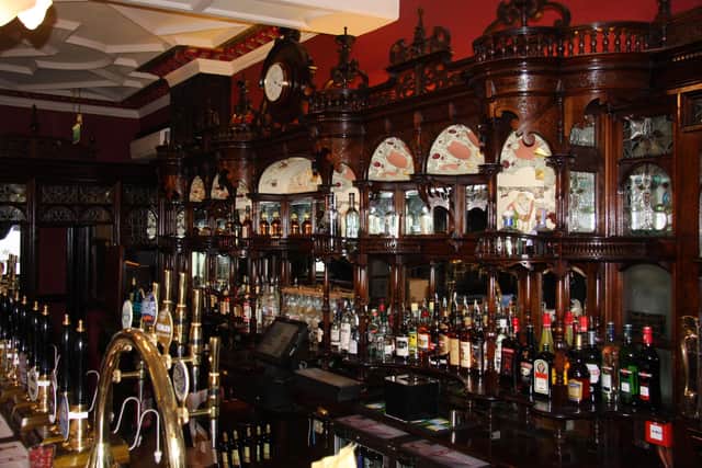 The historic wooden bar features of The Dun Cow