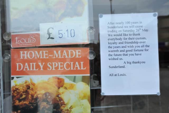 Sign in the window of Louis Cafe in 2018 announcing its closure