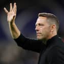 HUDDERSFIELD, ENGLAND - SEPTEMBER 13: Leam Richardson, Manager of Wigan Athletic acknowledges fans prior to the Sky Bet Championship between Huddersfield Town and Wigan Athletic at John Smith's Stadium on September 13, 2022 in Huddersfield, England. (Photo by Charlotte Tattersall/Getty Images)