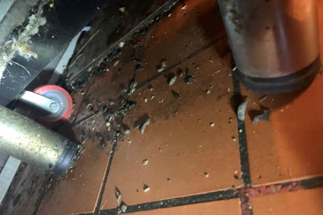 An image taken by environmental health inspectors under the food preparation area inside Curry Village, showing rat droppings.