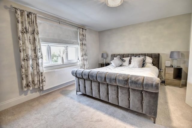 The master bedroom suite overlooks the rear garden and includes a large walk-in dressing area and a luxury en-suite shower room.