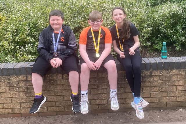 From left, weight lifting medallists James Newton, Jacob MacDonald and Libby Warwick Snow