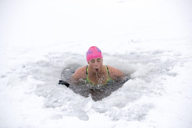 Alice Goodridge, from Newtonmore, plunges through a hole in the ice in Loch Insh, in the Cairngorms National Park.