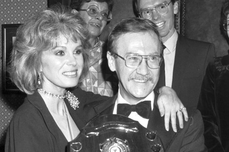 British stage and TV actress Joanna Lumley presents a Muscular Dystrophy fundraaising trophy to manager Alan Noble at the Beehive restaurant in Edinburgh, November 1986.