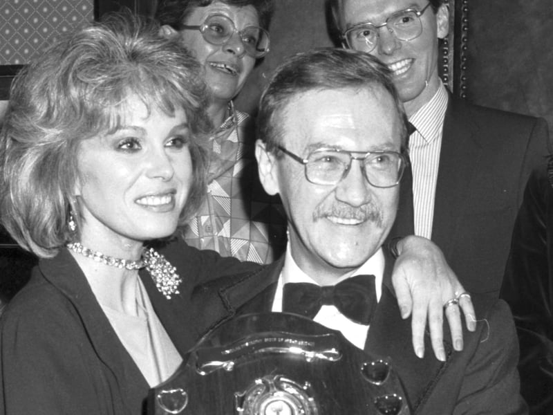 British stage and TV actress Joanna Lumley presents a Muscular Dystrophy fundraaising trophy to manager Alan Noble at the Beehive restaurant in Edinburgh, November 1986.
