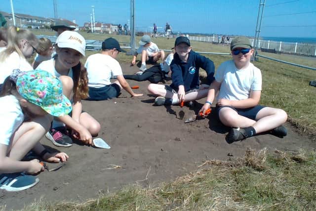 Year 4 pupils digging for artefacts at the site of the Roker Gun Battery.