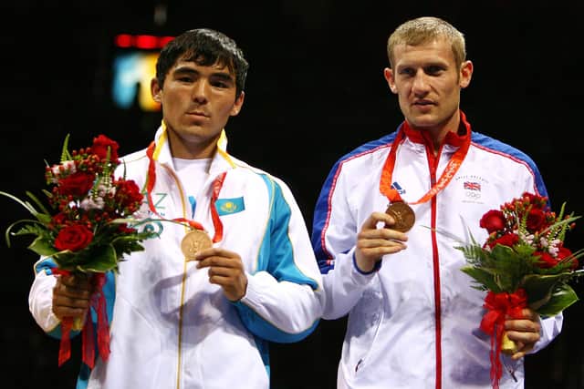 (L-R) Bronze medalists Yerkebulan Shynaliyev of Kazakhstan and Tony Jeffries of Great Britain celebrate with their medals following the Men's Light Heavy (81kg) Final Bout held at the Workers' Indoor Arena during Day 16 of the Beijing 2008 Olympic Games on August 24, 2008 in Beijing, China.