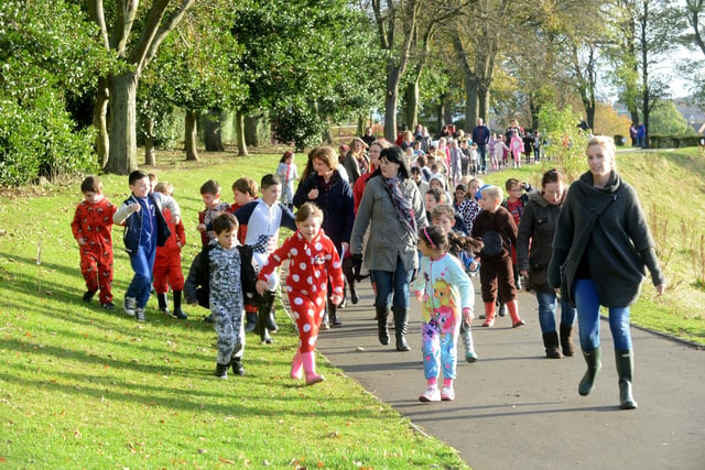 Staff and pupils of Barnes Junior School on their wellie and onesie walk through Barnes Park in 2014. Remember this?