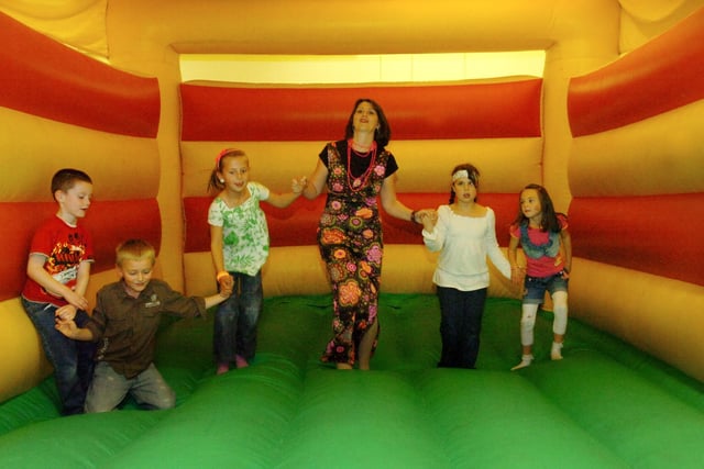 Lambton Primary School teacher Sarah Jones with some of her Year 3 class having fun on a bouncy castle. They were dressed in 70's costume as part of the school's 30th birthday celebrations 14 years ago.