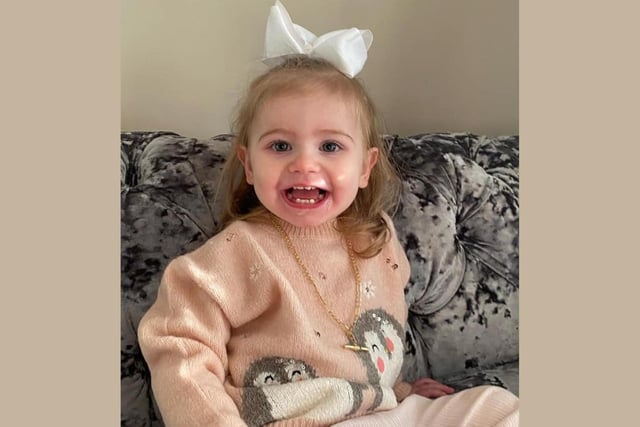 A big smile from Rosie Tindle, age 2, as she shows off her Christmas jumper.