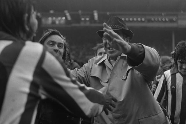 Bob greets his players after that famous run across the Wembley pitch.