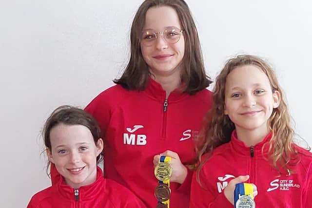 (Left to right) Sisters Molly Bowe, 8,  Marley Bowe, 13, and Macey Bowe, 10, with their 17 medal haul from two swimming competitions.