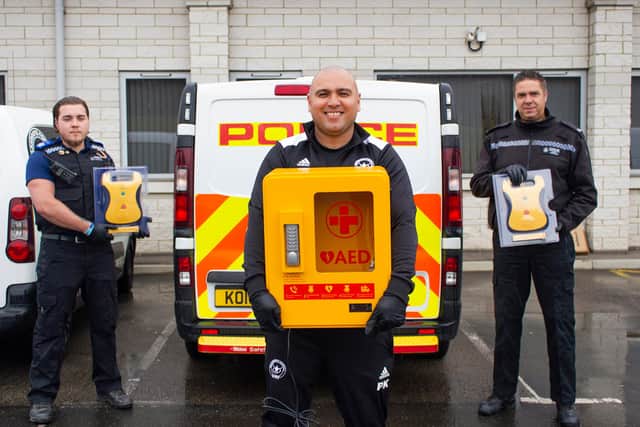 Pc Martin Thursfield, centre, with Police Community Support Officer Connor Smith, and Paul Kirton as the defibrillators were delivered.